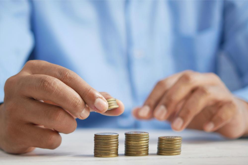 Person stacking coins on table